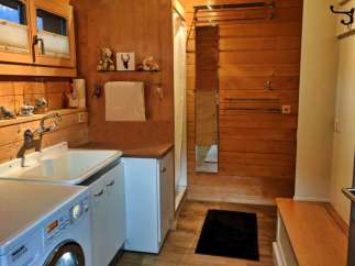 This cozy bathroom features a rustic wooden design, creating a warm and inviting atmosphere.