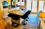 This stunning kitchen boasts a modern design with a sleek island, perfect for entertaining.