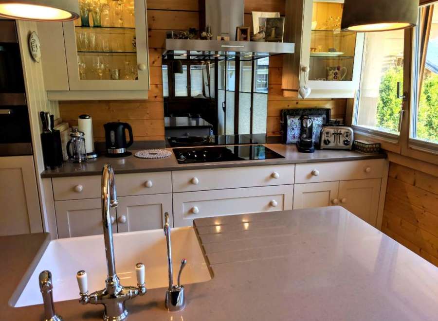 This stunning kitchen boasts a modern design with a touch of rustic charm, featuring sleek countertops and elegant cabinetry.