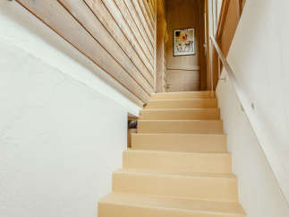 This inviting staircase leads to a cozy interior.