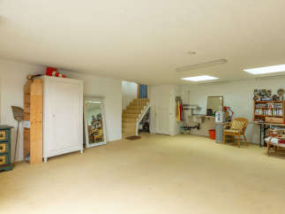 Spacious and versatile interior space, perfect for a workshop, studio, or additional living area.