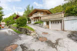 Charming wooden chalet nestled in a picturesque mountain setting.
