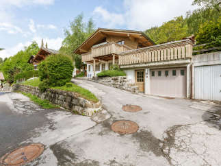 Charming wooden chalet nestled in a picturesque mountain setting.