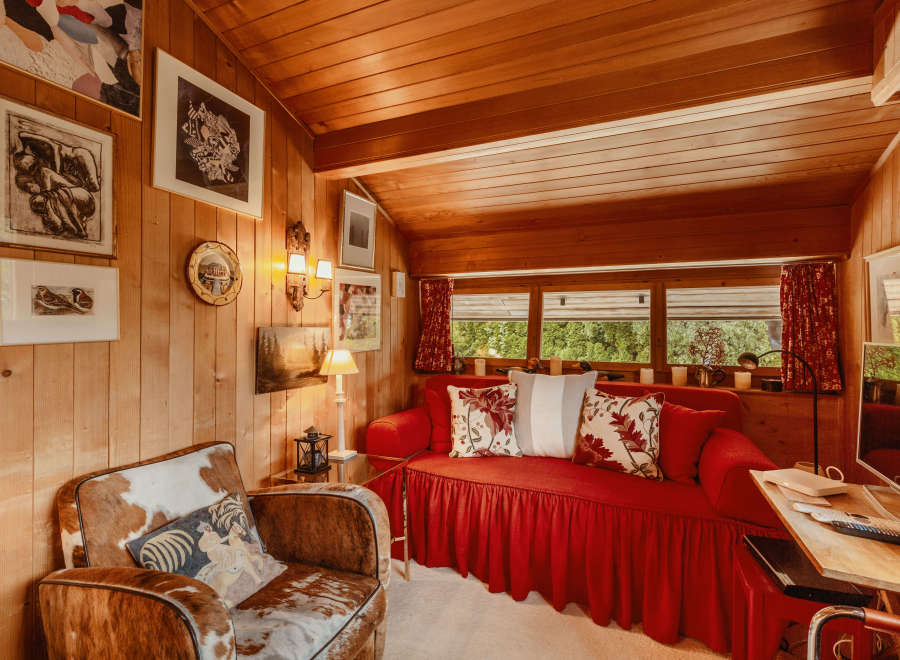 Step into a cozy cabin retreat with warm wood paneling and a charming ambiance.