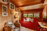 Step into a cozy cabin retreat with warm wood paneling and a charming ambiance.