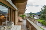 Enjoy breathtaking mountain views from this charming wooden balcony.