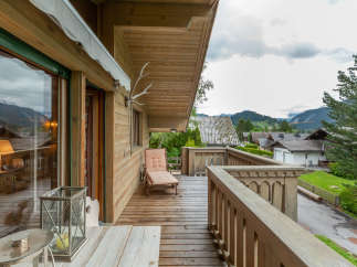 Enjoy breathtaking mountain views from this charming wooden balcony.