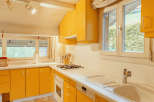 This charming kitchen boasts a vibrant yellow color scheme, creating a warm and inviting atmosphere.