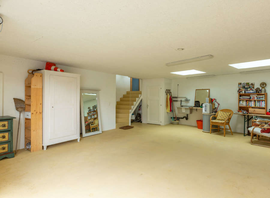 Spacious and versatile interior space, perfect for a workshop, studio, or additional living area.