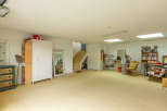Spacious and versatile interior space, perfect for a workshop, studio, or additional living area.
