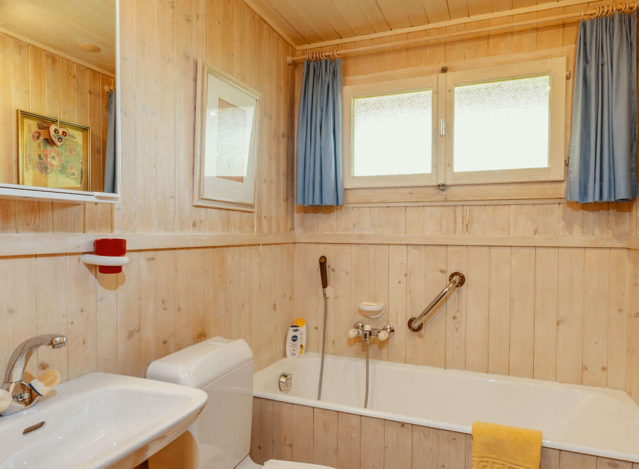 This cozy bathroom features a charming wooden interior, creating a warm and inviting atmosphere.