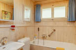 This cozy bathroom features a charming wooden interior, creating a warm and inviting atmosphere.