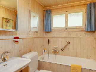 This cozy bathroom features a charming wooden interior, creating a warm and inviting atmosphere.