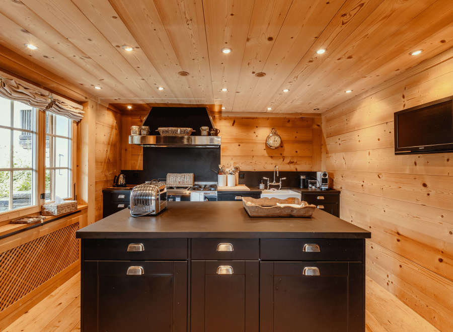 This stunning kitchen boasts a warm, inviting atmosphere with its beautiful wooden walls and ceiling.