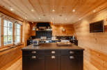 This stunning kitchen boasts a warm, inviting atmosphere with its beautiful wooden walls and ceiling.