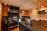 This stunning kitchen boasts a rustic charm with its warm wooden walls and ceiling.