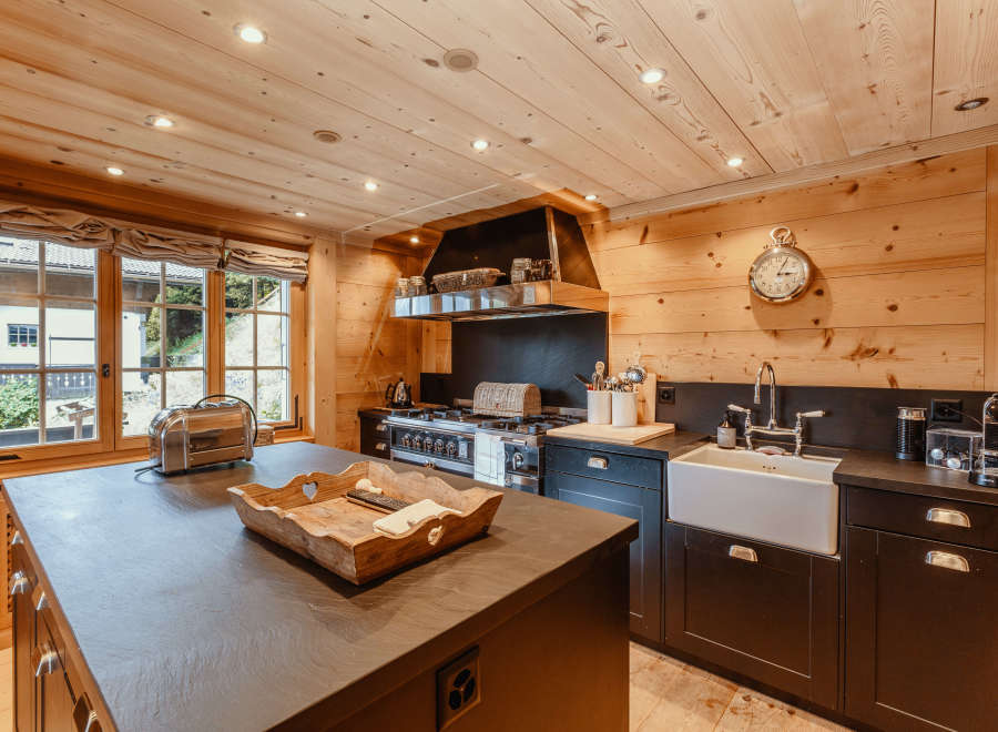 This stunning kitchen boasts a warm, inviting atmosphere with its beautiful wooden accents and modern appliances.