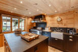 This stunning kitchen boasts a warm, inviting atmosphere with its beautiful wooden accents and modern appliances.
