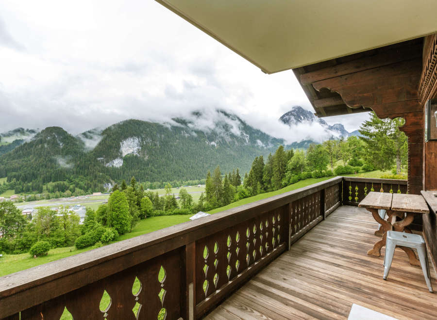 Enjoy breathtaking mountain views from this charming balcony.