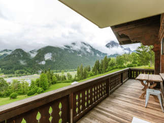 Enjoy breathtaking mountain views from this charming balcony.