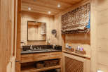 This cozy bathroom features beautiful wooden paneling throughout, creating a warm and inviting atmosphere.