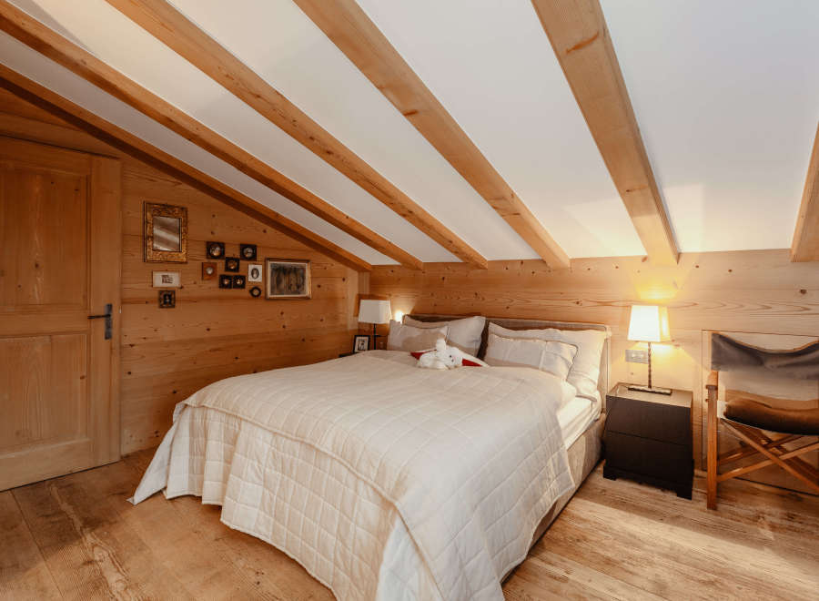 Cozy bedroom with wooden accents and a charming ambiance.