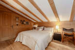 Cozy bedroom with wooden accents and a charming ambiance.