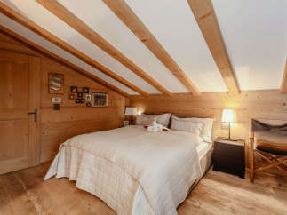 Cozy bedroom with wooden accents and a charming ambiance.
