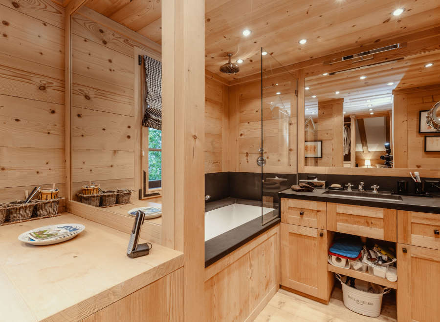 Step into a luxurious bathroom retreat, where natural wood paneling creates a warm and inviting atmosphere.