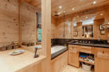 Step into a luxurious bathroom retreat, where natural wood paneling creates a warm and inviting atmosphere.