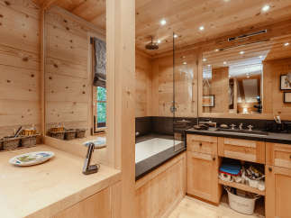 Step into a luxurious bathroom retreat, where natural wood paneling creates a warm and inviting atmosphere.