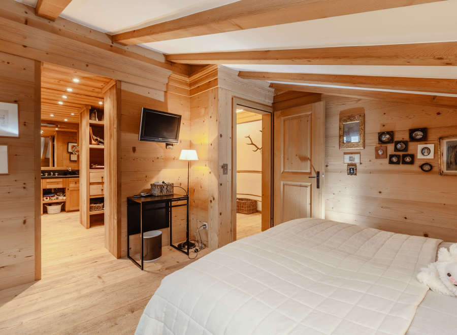 Experience the warmth of this cozy bedroom, featuring stunning wooden accents throughout.