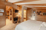 Experience the warmth of this cozy bedroom, featuring stunning wooden accents throughout.