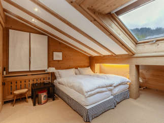 This cozy bedroom features a unique wooden design, creating a warm and inviting atmosphere.