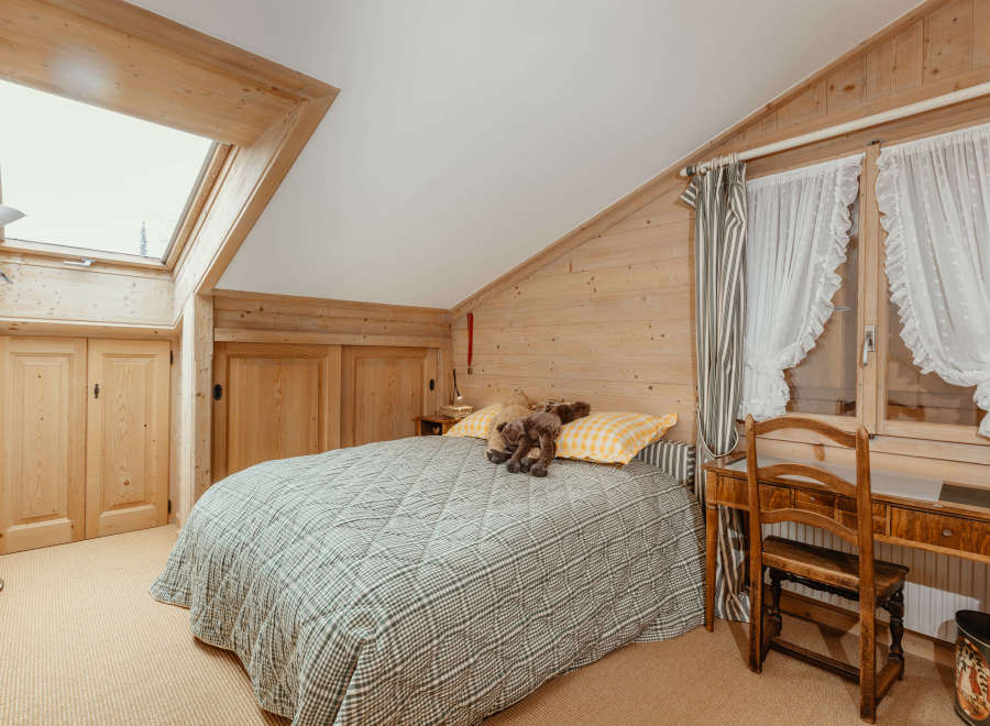 This cozy bedroom features a charming wooden interior, creating a warm and inviting atmosphere.