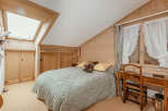 This cozy bedroom features a charming wooden interior, creating a warm and inviting atmosphere.