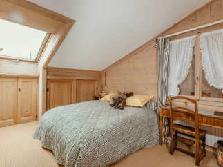 This cozy bedroom features a charming wooden interior, creating a warm and inviting atmosphere.