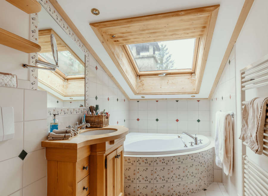 This charming bathroom features a unique skylight, allowing natural light to flood the space.