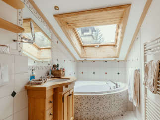This charming bathroom features a unique skylight, allowing natural light to flood the space.