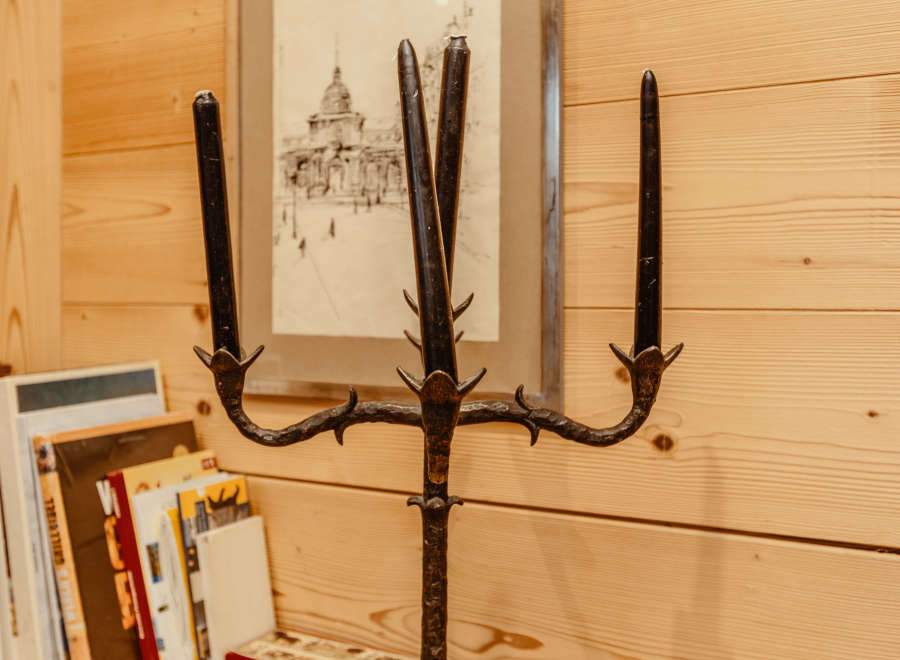 A unique, wrought-iron candelabra stands as a striking decorative element.