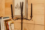 A unique, wrought-iron candelabra stands as a striking decorative element.