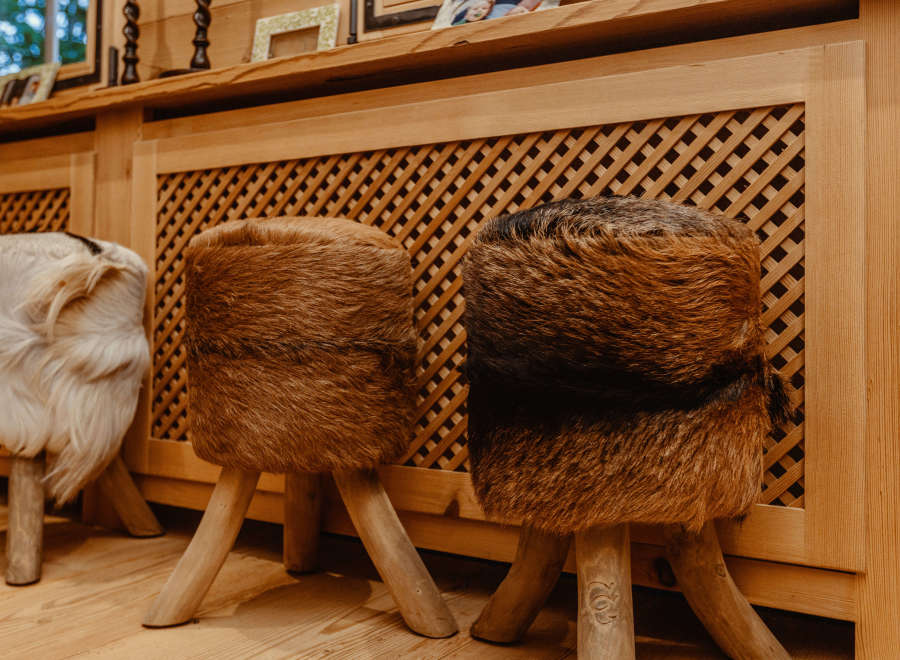Cozy up in this inviting space featuring unique fur-covered stools.