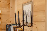 This cozy space features beautiful wooden walls and a rustic wooden shelf.