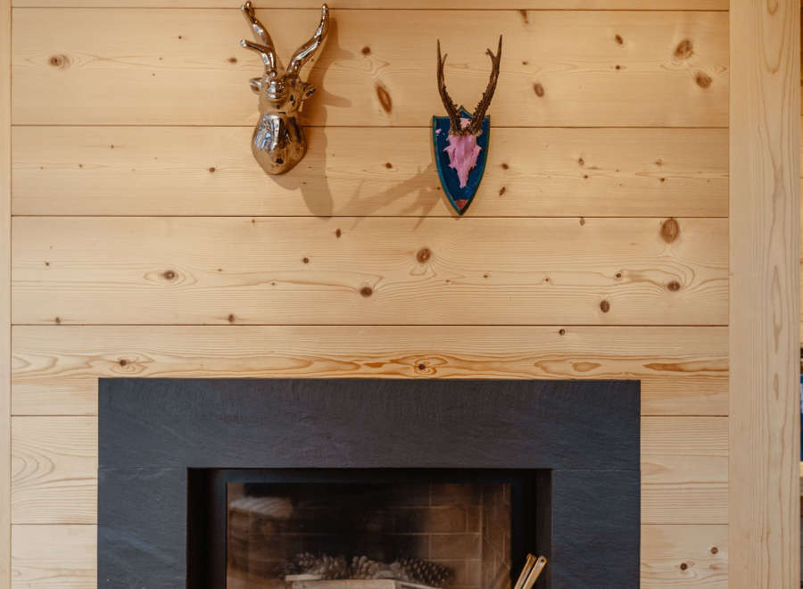 This cozy living space features a stunning fireplace with a sleek, dark surround, perfect for those chilly evenings.