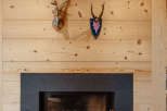 This cozy living space features a stunning fireplace with a sleek, dark surround, perfect for those chilly evenings.