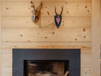 This cozy living space features a stunning fireplace with a sleek, dark surround, perfect for those chilly evenings.