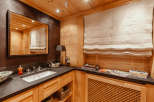 This luxurious bathroom features a warm, inviting ambiance with its wooden paneling and elegant design.