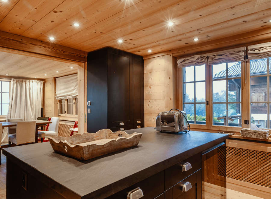 This stunning kitchen boasts a warm and inviting atmosphere with its wooden ceiling and walls.