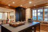 This stunning kitchen boasts a warm and inviting atmosphere with its wooden ceiling and walls.