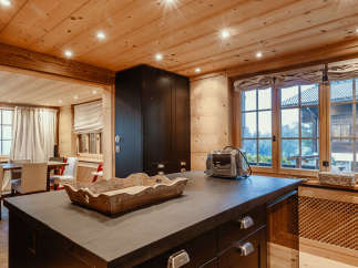 This stunning kitchen boasts a warm and inviting atmosphere with its wooden ceiling and walls.
